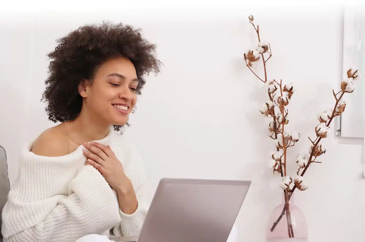 Young Black woman confident and empowered through teletherapy at Advanced Client Care