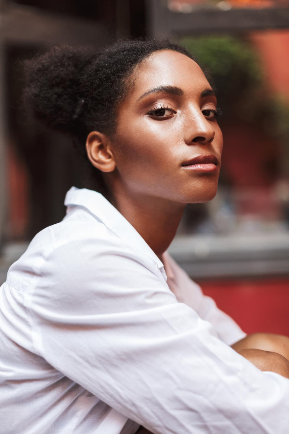 Young Black woman with styled locs and a nose ring smiling confidently, reflecting the positive impact of individual online therapy at Advanced Client Care