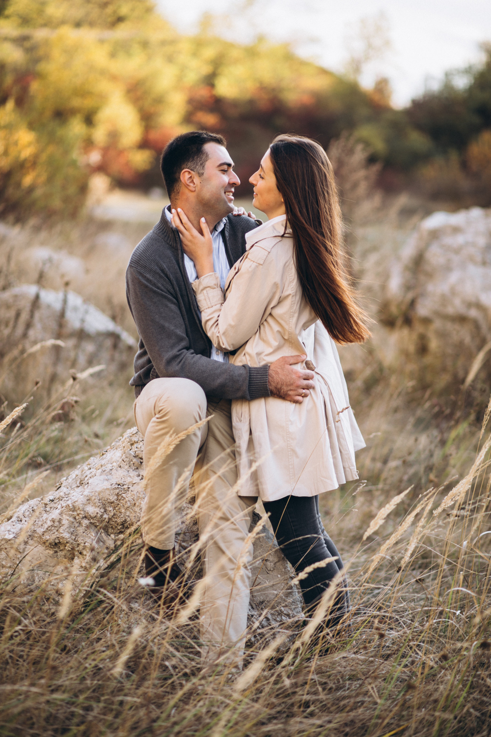 A woman rests her hand on the neck of a man beside her outdoors, reflecting relationship connection through couples counseling at Advanced Client Care