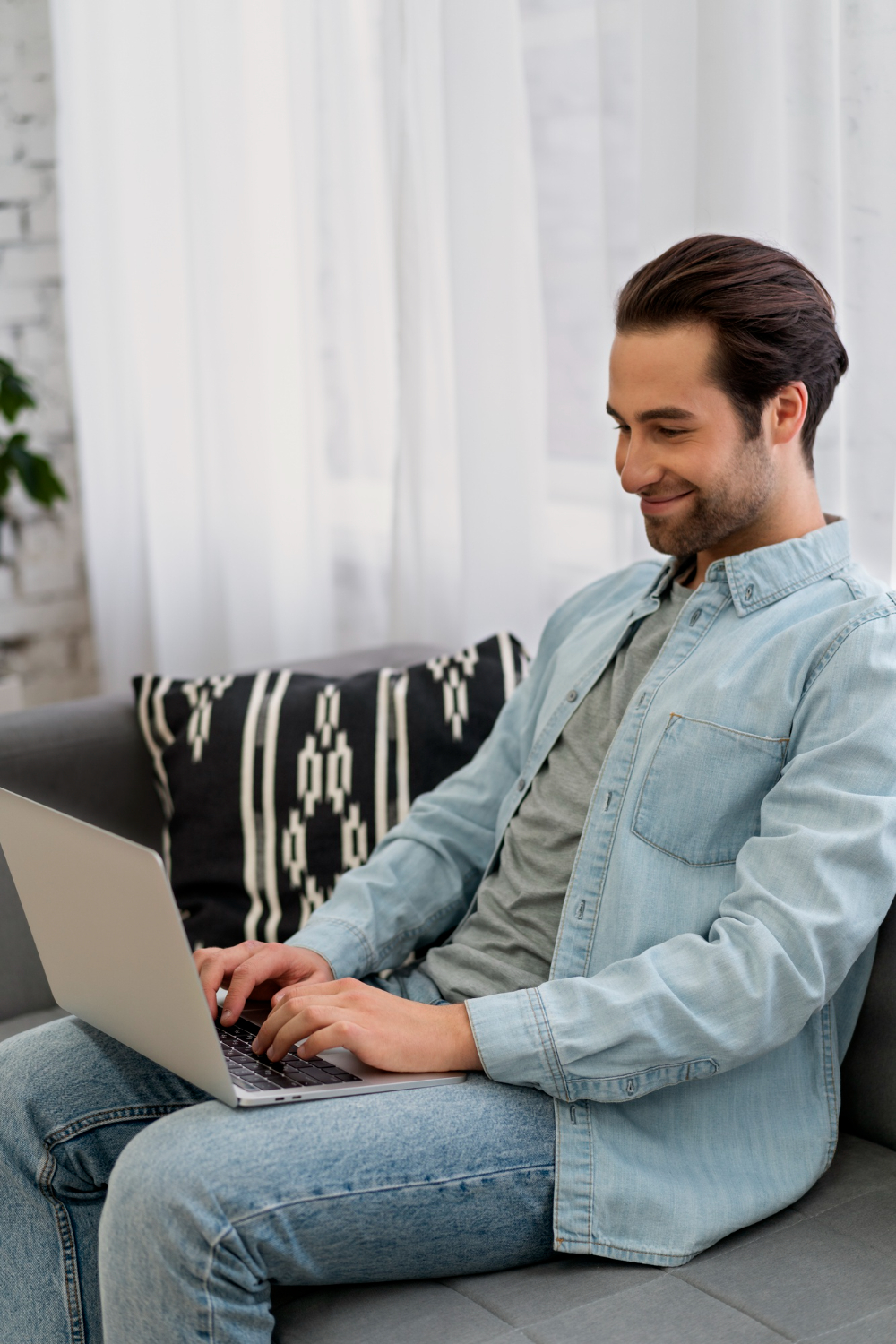 Person working on a laptop in a comfortable home setting, representing flexible virtual substance abuse counseling at Advanced Client Care